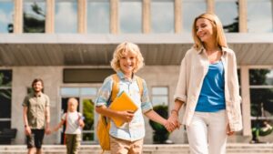 young-parents-escorting-their-kids-children-from-school-home-after-picture-id1338737831