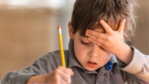 little-boy-doing-his-homework-pre-school-classroom-pupil-confused-uneasy-thinking